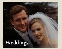 Head shot of bride and Groom - bride is wearing veil folded back away from her face - with word &quot;Weddings&quot;